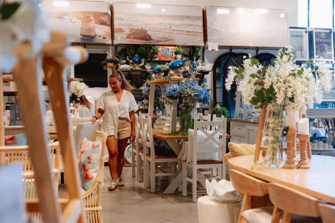 Woman browsing furniture and homewares in a retail store